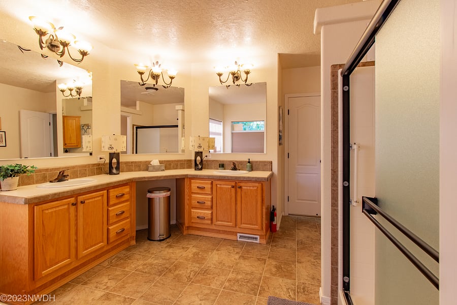 Expansive vanity with abundant storage cabinets/drawers and double sinks