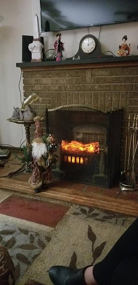 Fire place is with electric real sounding logs that light up and heat up the area. 