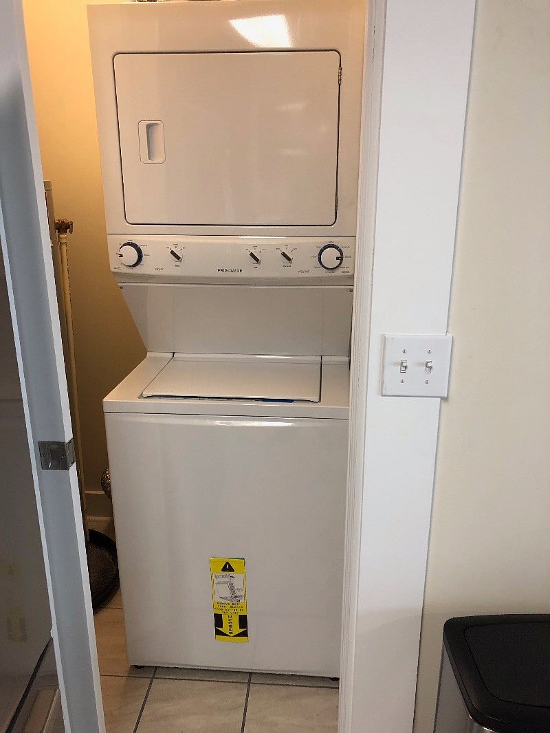 Washer and dryer behind the pocket door by the refrigerator