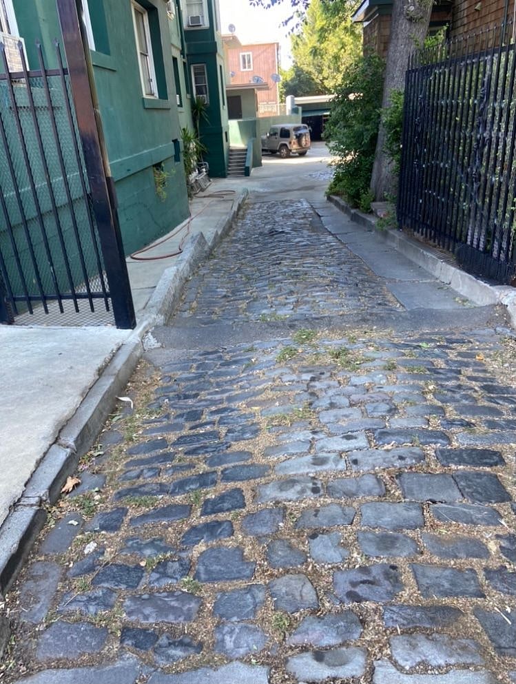 Cobble Stone Driveway over 100 years old that leads to our parking lot on the side of the building with a back entrance