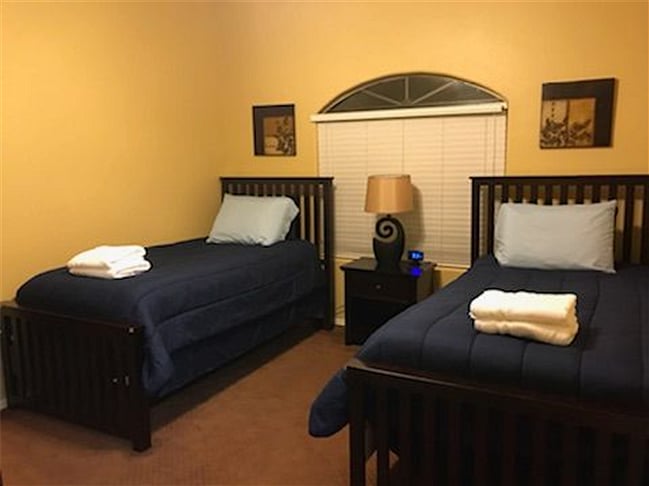 Guest bedroom with 2 twin beds. Queen bed option is available upon request if needed