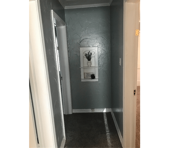 Bedrooms are located on adjacent sides of hallway.