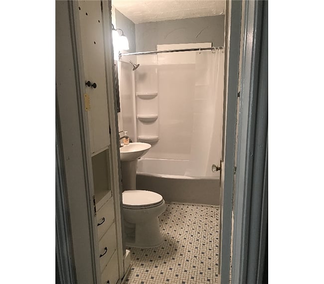 Bath has tub and shower.