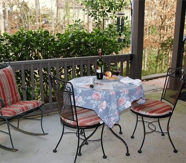 Patio area overlooking wooded yard & creek.