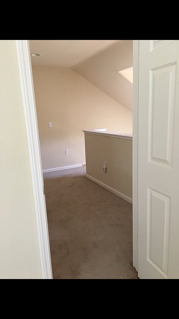 Door between small sitting area and bedroom