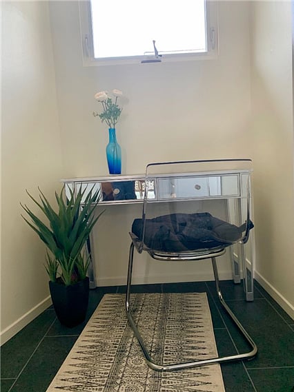 Walk-in closet has a nifty workspace built-in, that can be closed off as needed with a handy pocket door.