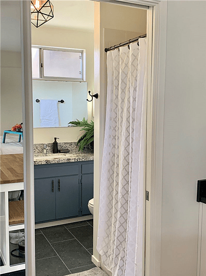 Crisp bathroom with plush towels, a pebble-bottom shower (great water pressure!), lots of storage, space and light - from atmospheric to necessity. Quiet, new bath fan.