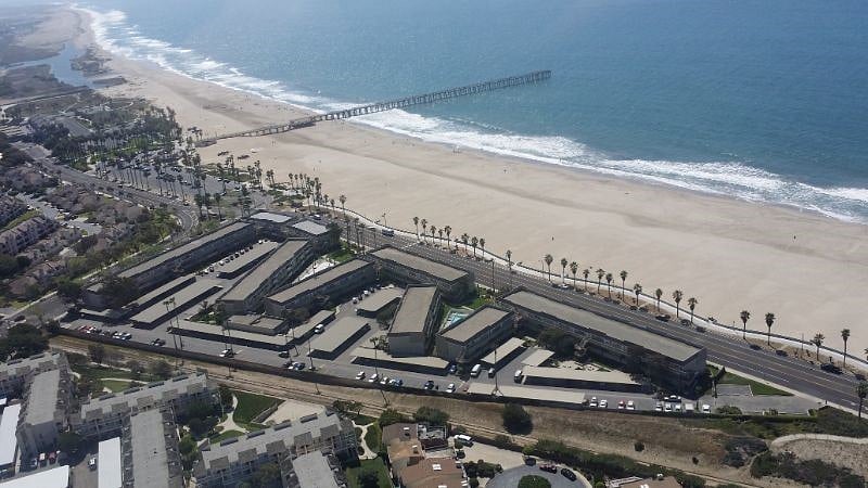 An aerial view of the beach pier at the end of the pier is a great seafood restaurant which r\frequently has live entertainment.