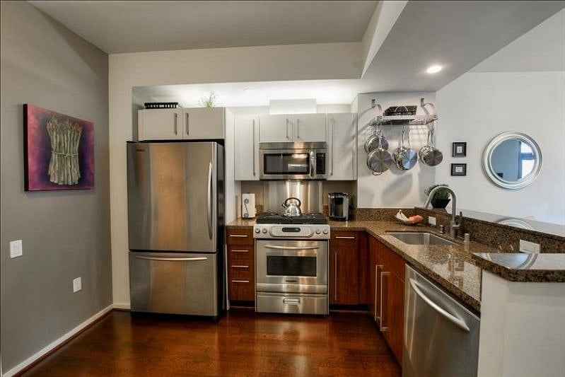 Fully equipped kitchen with stainless steel appliances.