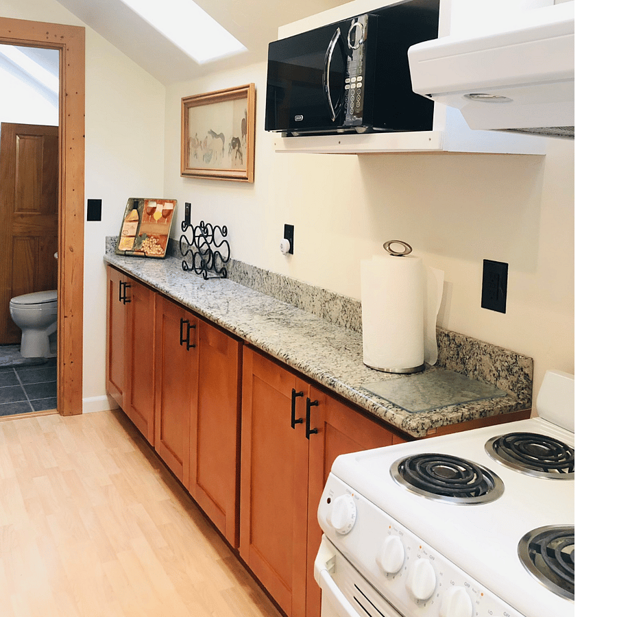 Spacious  Kitchen  Features a Huge granite counter for meal prep and dining Complete with comfortable Chairs . Well stocked for the Chef