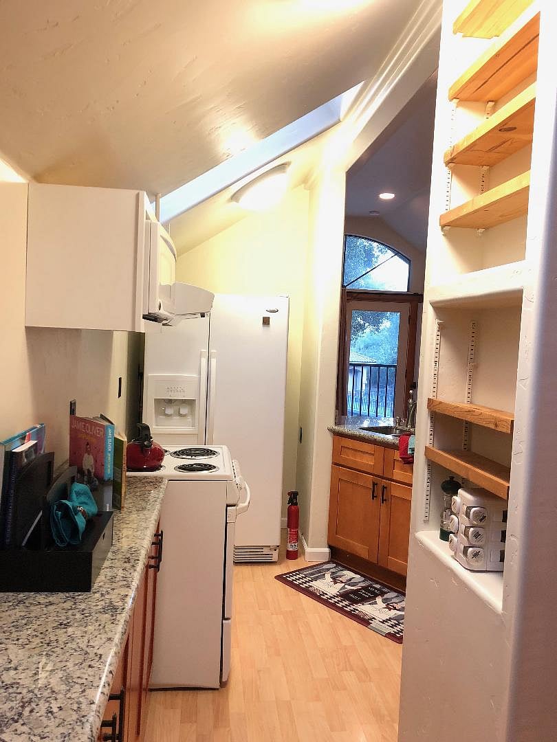 Spacious  Kitchen  Features a Huge granite counter for meal prep and dining Complete with comfortable Chairs . Well stocked for the Chef