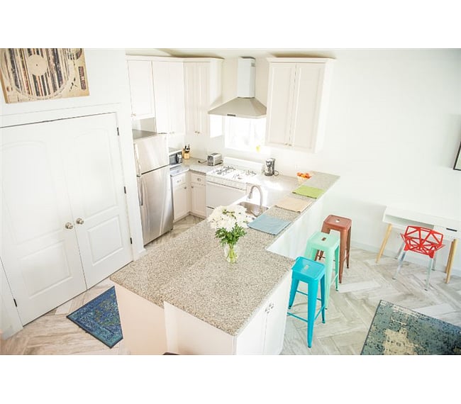 Fully furnished kitchen with pots, pans, dishes, silverware, and cups. Gas stove and oven to evenly and quickly prepare food.
