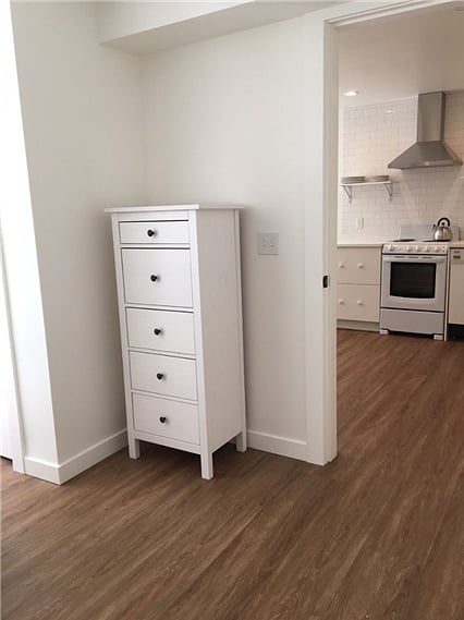 View from bedroom into the kitchen. New dresser for tenant use.