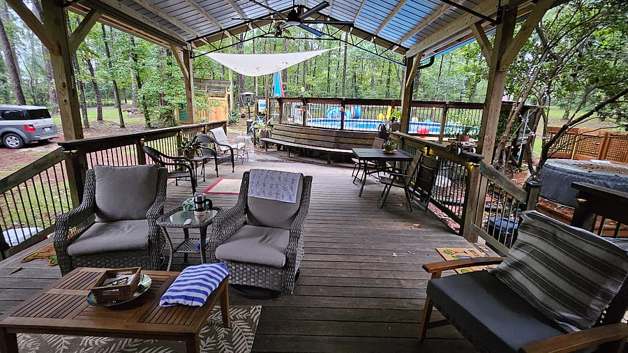 Relaxing Back deck with outdoor TV and ceiling fans.