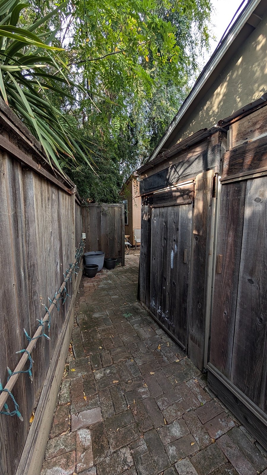 Enter east gate walk to backyard to cottage.
The cottage is centerered in the photo