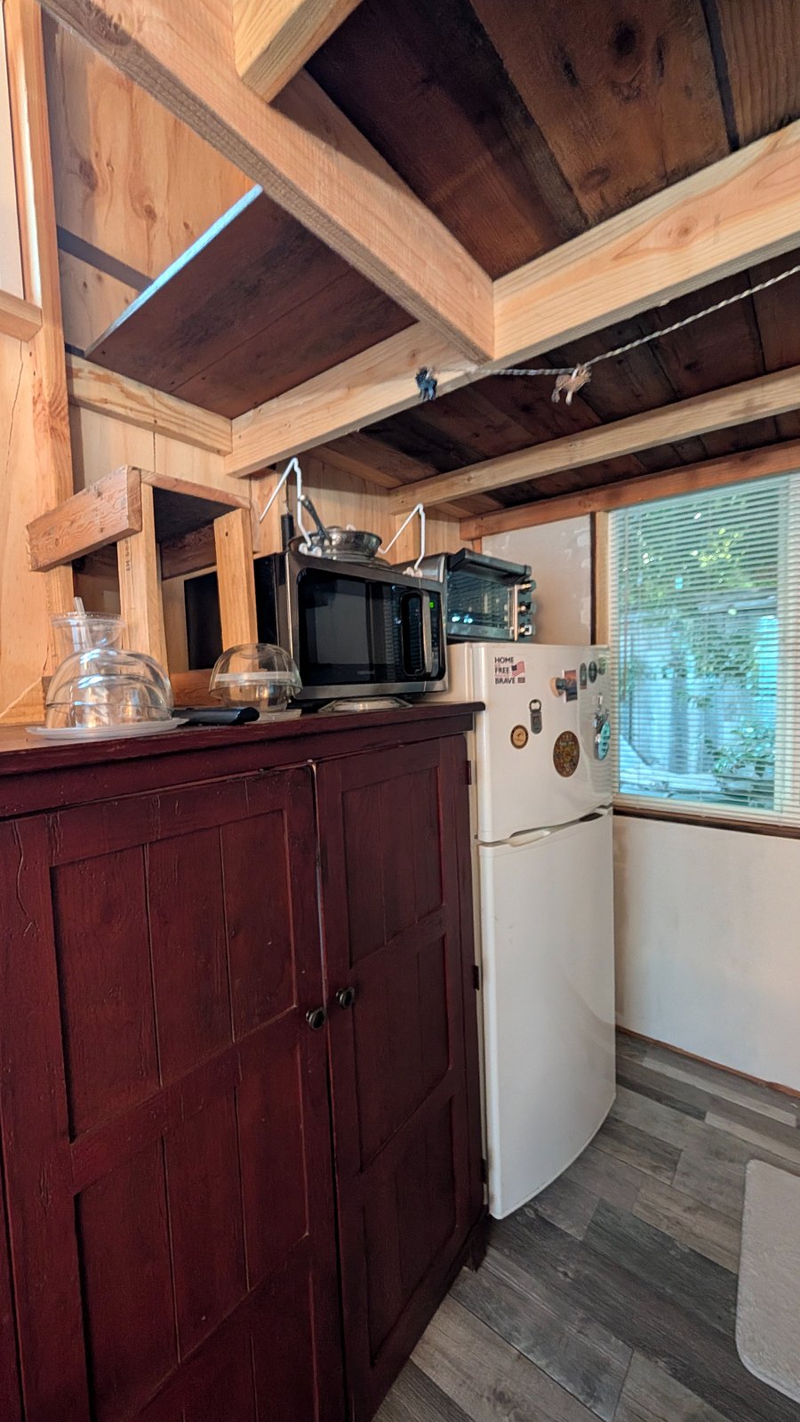 Microwave, refrigerator, convection oven, drip coffee maker (not seen) & east window