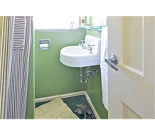 Your little frog-green bathroom is now light grey with matching towels.