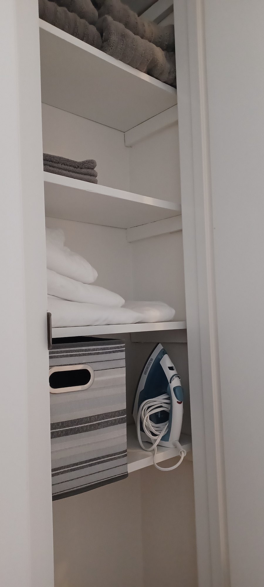 Linen closet stocked with sheeets and towels in all apartments