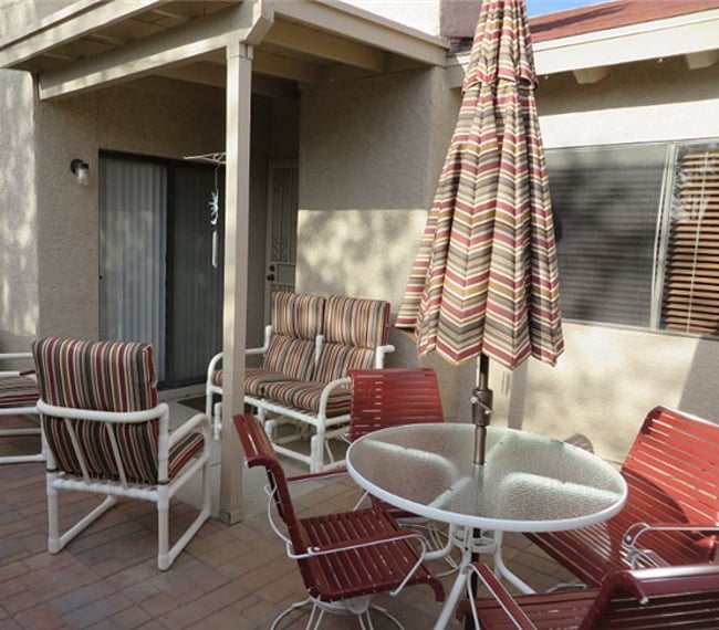 Back patio (walled in) with barbeque and patio furniture