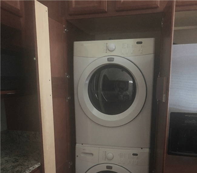 Inside, full size, hidden in cabinet washer and vented dryer.
