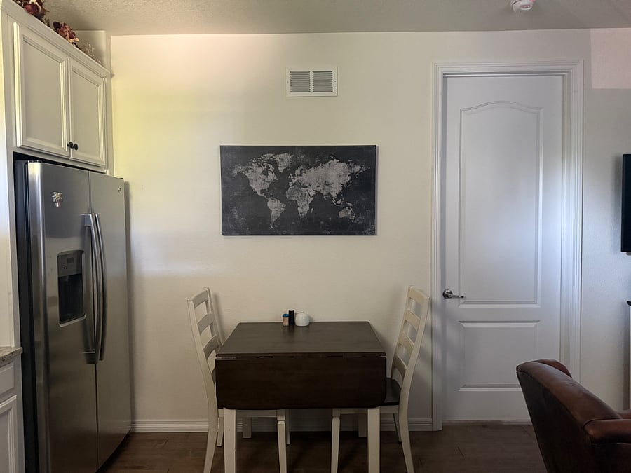 Table and chairs (table has leaflet on each side)