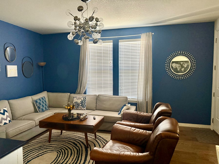 Spacious living room with couch and two chairs