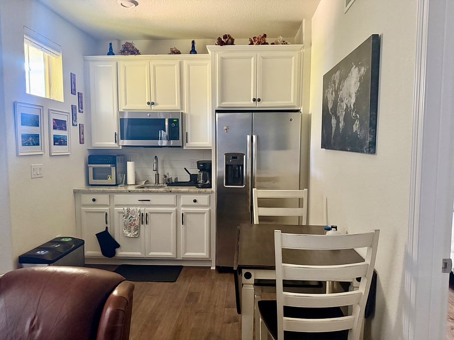 Kitchenette with table and chairs (table has leaflet on each side)