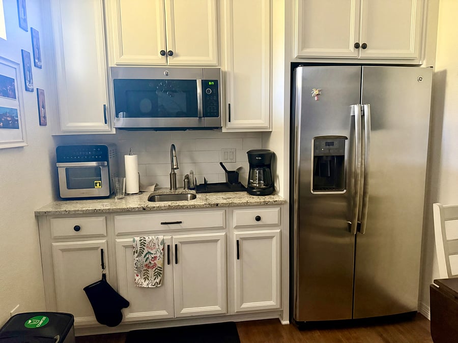Kitchenette with full fridge and freezer, water dispenser, air fryer, microwave, electrical burners, plates, cups, glasses, utensils, etc.