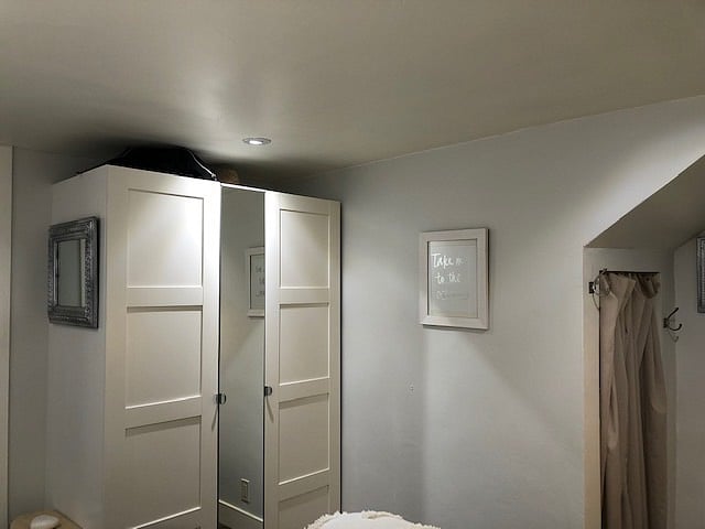 Double side clothes closet with three pull-out drawers.