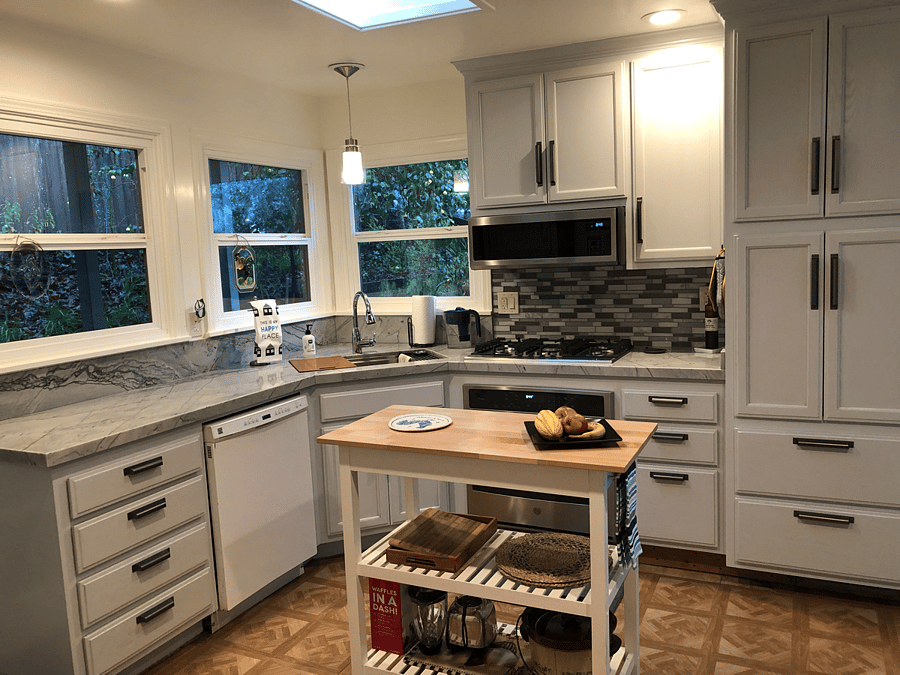 Newly remolded kitchen. New range cook top, oven, microwave, sink with built in work space, garbage pull out, painted cabinetry with new handles, and kitchen counters