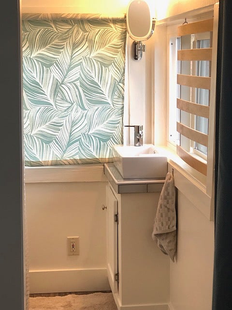 Upstairs bathroom. Sink, toilet, shower, and a mirror with built in lighting.  USB chargeable.