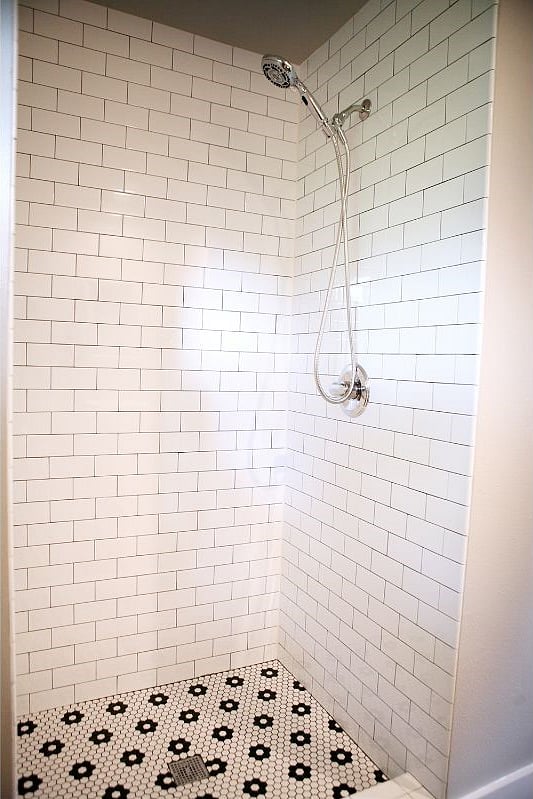 This shower includes small octagonal tiles to prevent slipping & both showers include a removable shower head to make rinsing off and cleaning the shower easier.