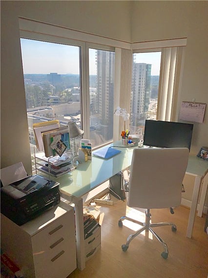 Office area equipped with a desk, chair, and printer.