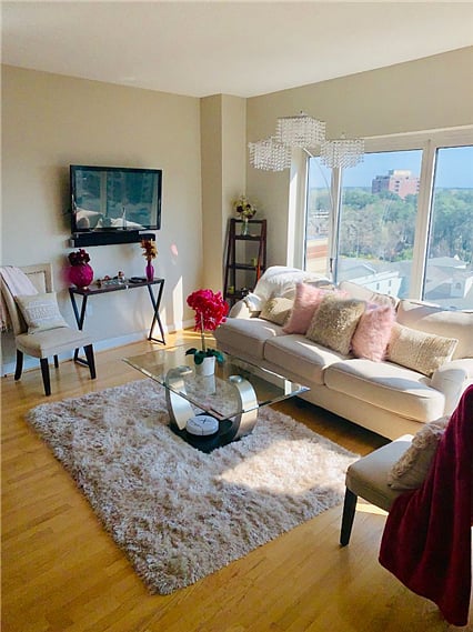 Spacious living room featuring a TV and a Queen-sized pullout sofa.