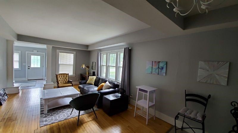 In this shared living room, you can enjoy the comfy couch and the smart TV. If you need to work, there is a regular desk and a standing laptop table.