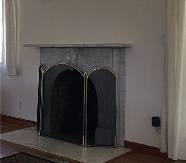 Marble-mantel decorative fireplace that enhances the cozy feeling of the Main Bedroom