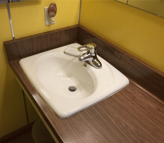 Ejler sink with Hans Grohe faucet. A mirror is above as well as a medicine cabinet