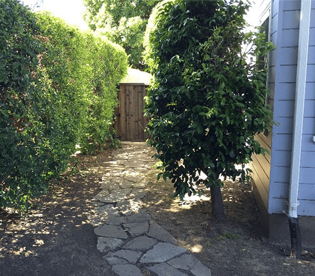 The gate to the studio is reached by a stone path from the property entrance 