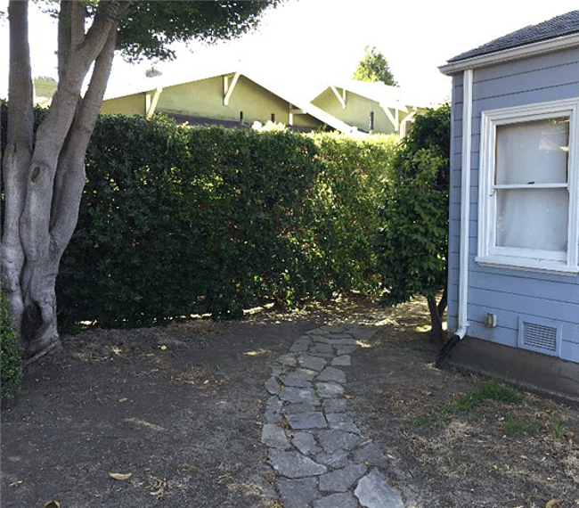 The stone path follows along the corner to the owner's house and reaches the gate shown in the previous picture