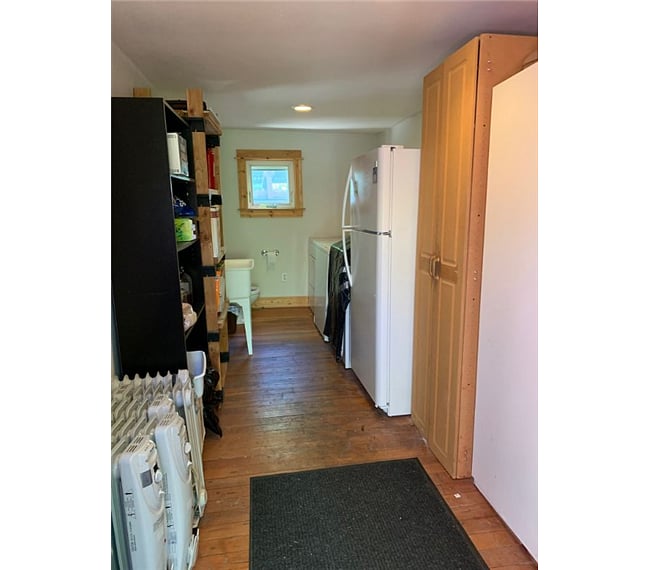 community utility room with washer/dryer/full refrigerator