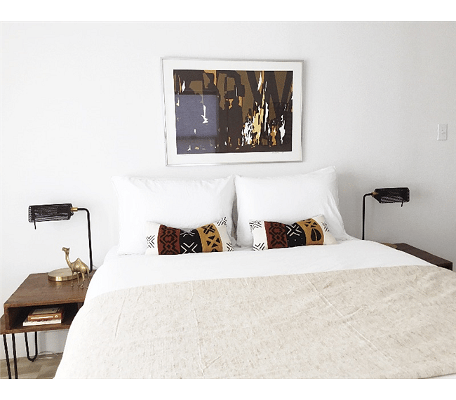 Wake up to beautiful morning light and savor a delicious cup of coffee in the fresh, open master bedroom that features a queen size bed, organic cotton linens, and original traditional African textiles. 