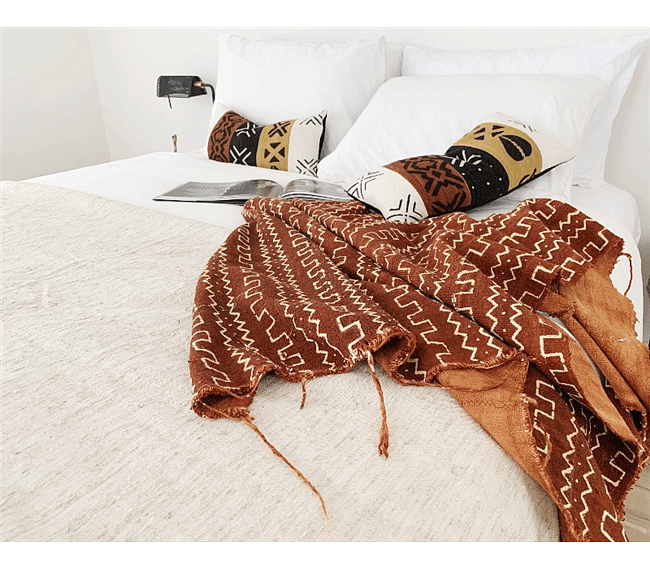 Wake up to beautiful morning light and savor a delicious cup of coffee in the fresh, open master bedroom that features a queen size bed, organic cotton linens, and original traditional African textiles. 