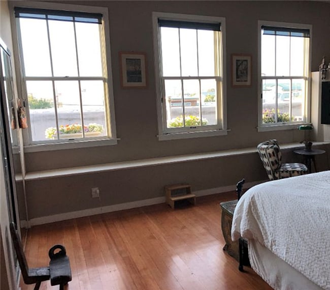 The bedroom has three windows giving out onto the East Bay hills, facing Northeast so you can see the sunrise. Gas fireplace heats up the whole unit and looks cozy with glowing stones when turned on. Shades darken the room for sleeping.

