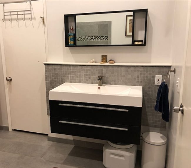 Wide sink in bathroom with double drawers below great for two people to share and store all their toiletries.
