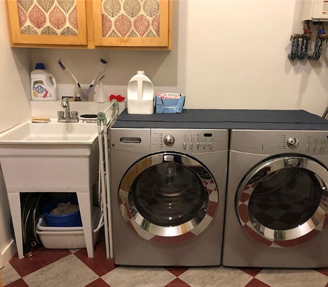 Laundry room with full size washer and dryer and a utility sink. Laundry soap provided.
