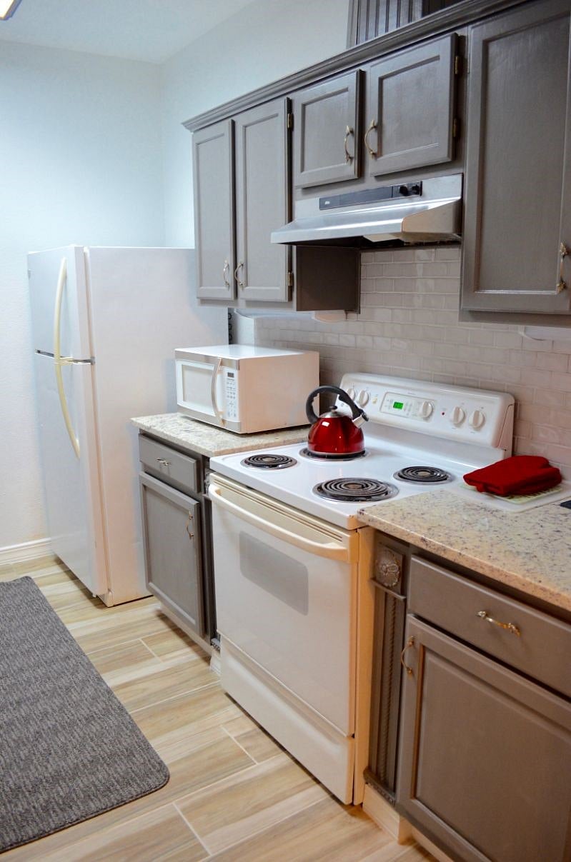Remodeled Kitchen with granite counters and microwave oven.