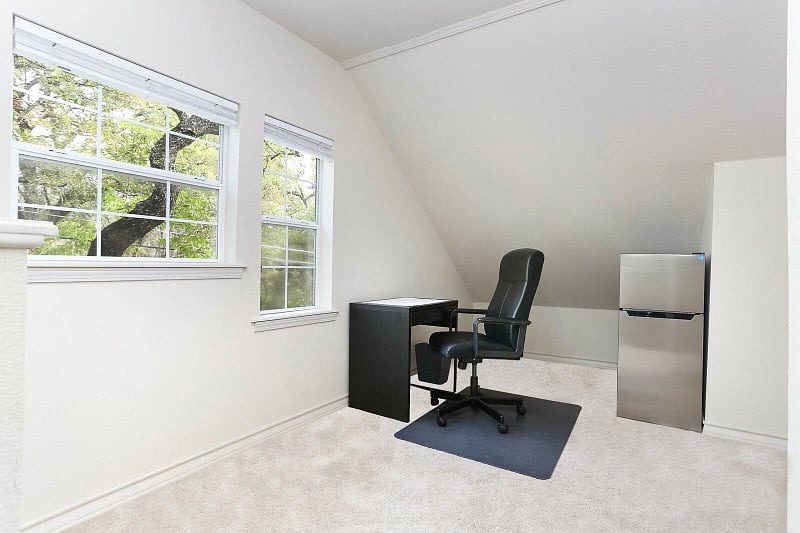 Office area with small fridge upstairs.