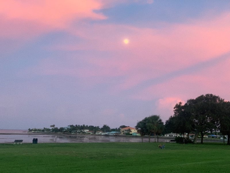 The moon rising over the bay
