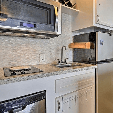 Kitchen with dish washer, stove top, convection microwave and frig
