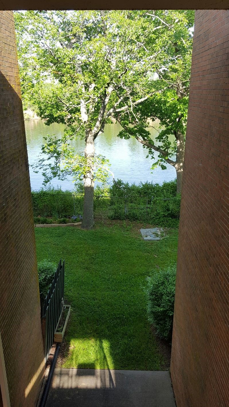 Front Balcony views of the Cumberland River. A table and chairs allow for enjoying to the view.